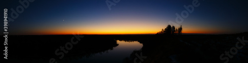 Panoramic view of the river. Evening sky after sunset.