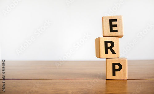 ERP symbol. Concept word 'ERP - enterprise resource planning' on cubes on a beautiful wooden table, white background. Business and ERP concept. Copy space.