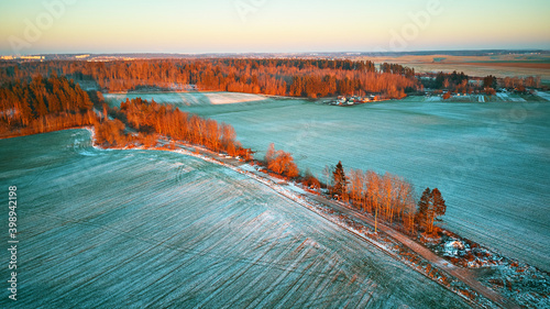 Colorful trees December sunset Aerial scene. Rural dirt road. Countryside top view.