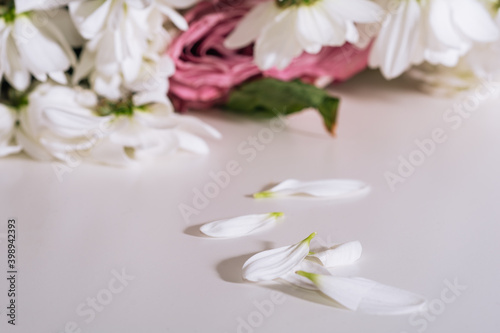 Bouquet of faded flowers on the white table