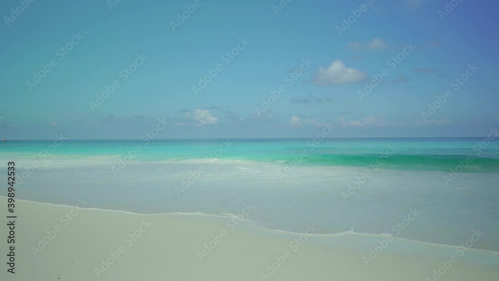 Exotic beach by the ocean with rolling waves on the sandy shore and blue sky. Timelaps Exotic beach by the ocean with rolling waves on the sandy shore and blue sky. Timelaps