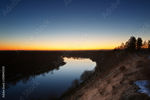 View of the river from the cliff. Evening sky after sunset.