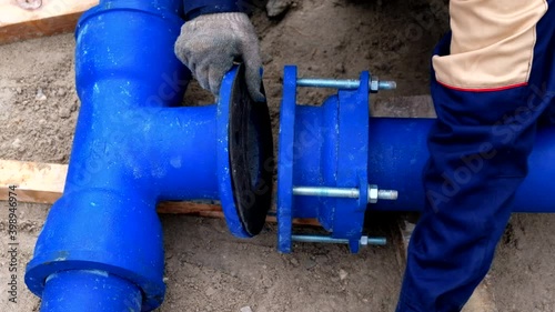 Wallpaper Mural Workers installing water supply pipeline system, close up Torontodigital.ca