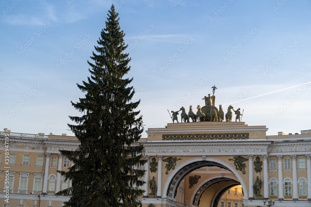 Christmas evergreen fir tree with no decorations on Palace square in Saint Petersburg, arch of the General Staff on background. 
