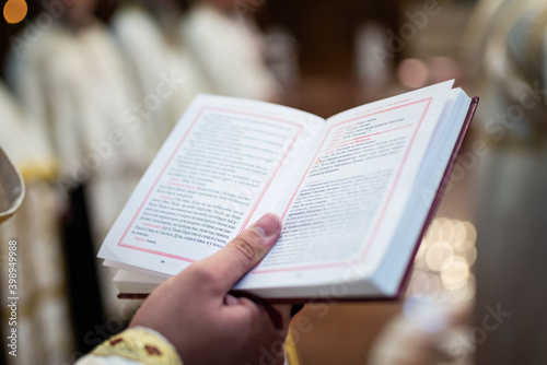 Reading Holly bible book in Orthodox church during wedding ceremony