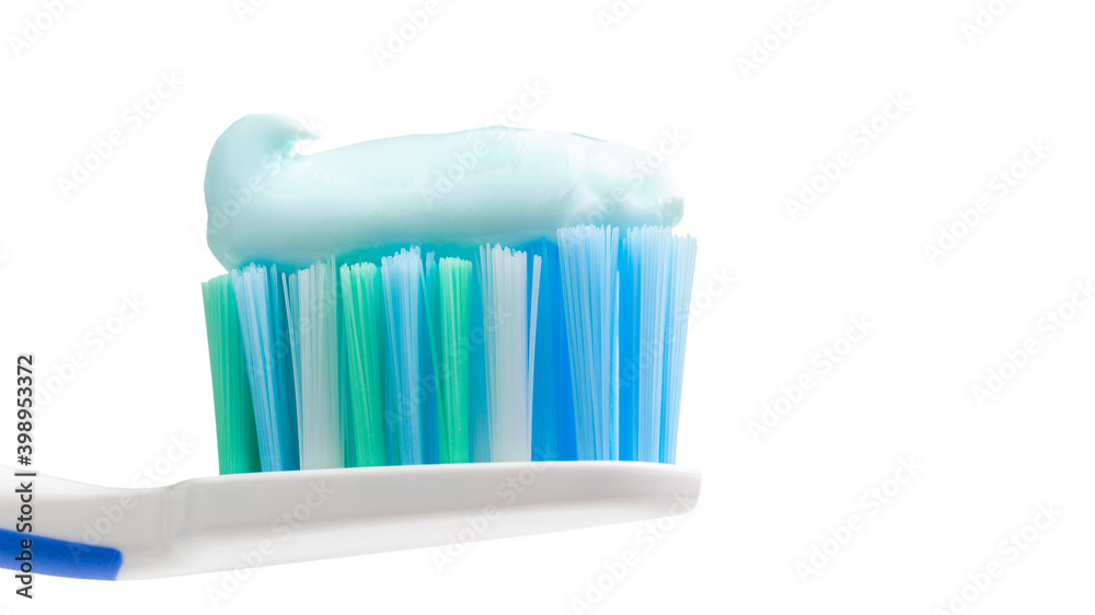 Toothbrush head with toothpaste, close-up view, isolated on white background, macro Toothbrush head with toothpaste, close-up view, isolated on white background, macro