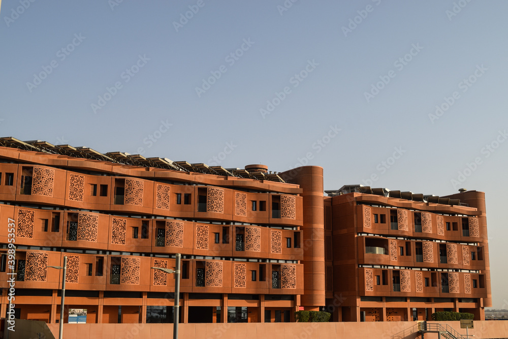 Facade of Masdar Institute Campus, in Masdar City, in contrast with the blue sky. Abu Dhabi, United Arab Emirates. Facade of Masdar Institute Campus, in Masdar City, in contrast with the blue sky. Abu Dhabi, United Arab Emirates.