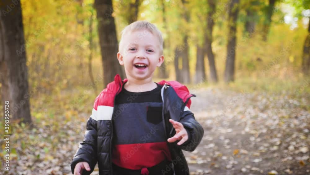 Happy baby boy running in autumnal park. Little child playing on autumn walk. Autumnal forest with golden leaves. Steadicam video, 4K slow motion. Happy baby boy running in autumnal park. Little child playing on autumn walk. Autumnal forest with golden leaves. Steadicam video, 4K slow motion.