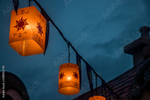 Lanters hanging on a wire at night photo