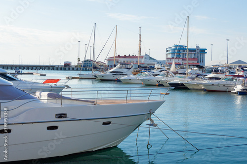 White yachts in the port. Boats in the blue water harbor.