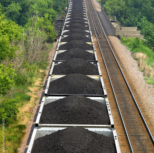 Long train of railroad wagons full of coal