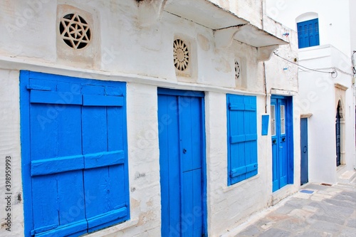 View of a house decorated with blue door and windows and marble lintel at the traditional village of Pyrgos in Tinos island, Greece, April 14 2012. © Theastock