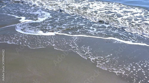 the waves of the mediterranean sea roll on the city beach