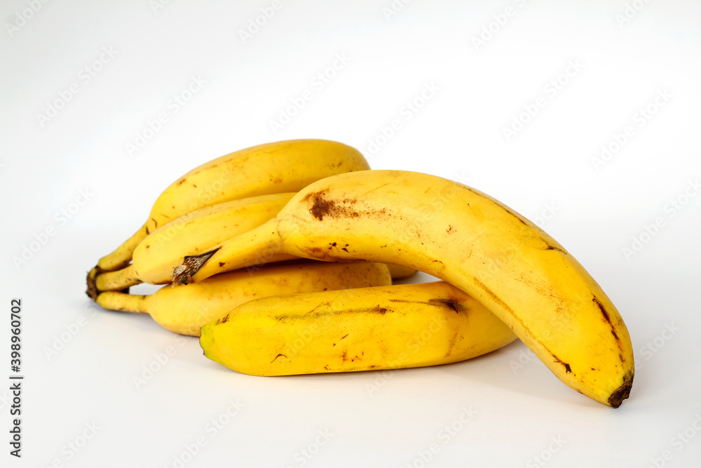 Bananas with some dark spots with shadow isolated on white background.