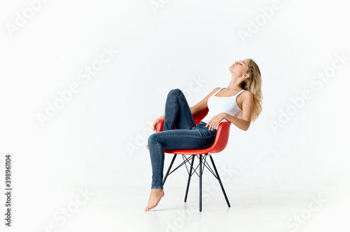 women in a red armchair in a bright room portrait interior model 