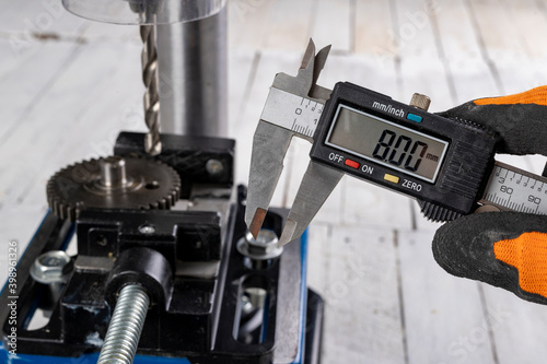 Drilling a hole in metal. Metal works performed with a drill.