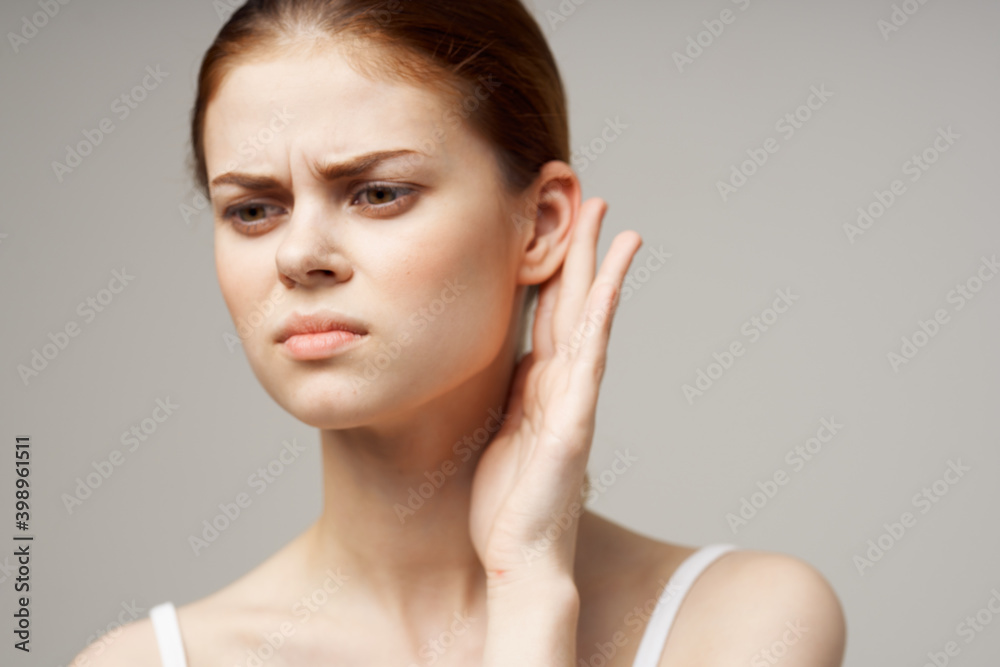 disgruntled woman holding her ear health problems close-up disgruntled woman holding her ear health problems close-up
