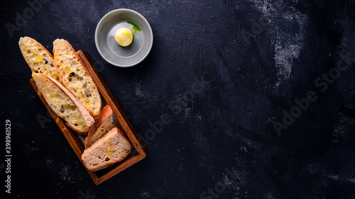 Delicious homemade italian ciabatta bread on dark concrete background, above view Free copy space