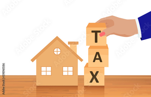 Vector of a house and a business man composing the word tax from wooden cubes photo