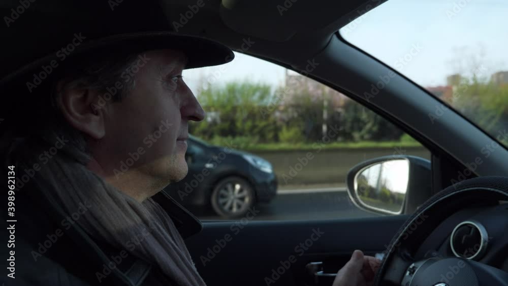 Close-up Elegant Mature Man Dressed in Winter Attire and Hat Drives Car on Highway. 2x Slow motion 60 fps 4K Close-up Elegant Mature Man Dressed in Winter Attire and Hat Drives Car on Highway. 2x Slow motion 60 fps 4K