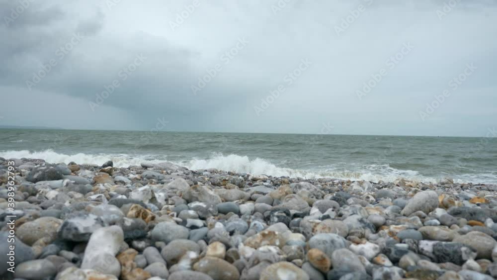 Stormy Sea. Stony Seashore. Waves Crashing on Pebble Beach. Atlantic Ocean. Grey Overcast Sky. English Channel. Le Havre Normandy France Europe. 2x Slow motion 60 fps 4K Stormy Sea. Stony Seashore. Waves Crashing on Pebble Beach. Atlantic Ocean. Grey Overcast Sky. English Channel. Le Havre Normandy France Europe. 2x Slow motion 60 fps 4K
