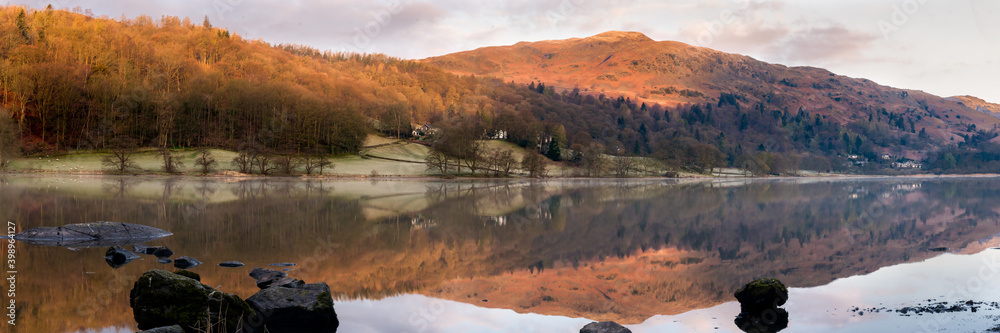  Panoramic view of Grasmere at dawn in the Lake District National Park with reflection