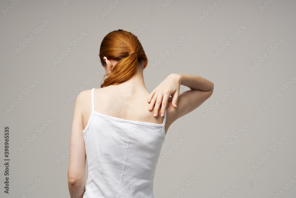 woman white t-shirt touching her shoulders with hands cropped view close-up woman white t-shirt touching her shoulders with hands cropped view close-up