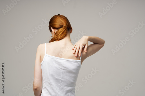 woman white t-shirt touching her shoulders with hands cropped view close-up