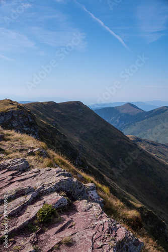 Impressive view from a Midzor mountain peak summit, the highest peak of Old mountain,2169 meters above sea level, and a view to surrounding peaks and highlands at summer Old Mountain in Serbia, Europe © Dragan
