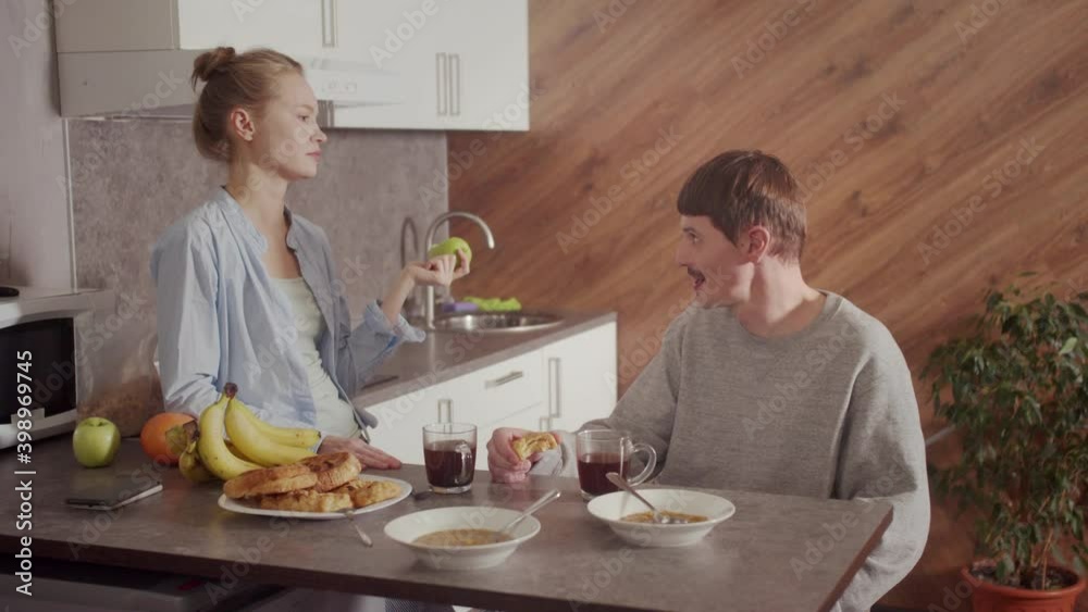 Family quarrel between husband and wife. Relationships within a young family.The young people had a fight at dinner and the husband left the table. Family quarrel between husband and wife. Relationships within a young family.The young people had a fight at dinner and the husband left the table.