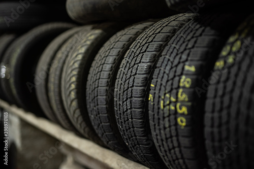 Stack of used tires at the car service waiting for disposal