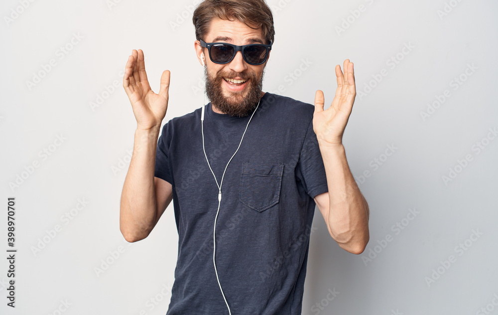 Fototapeta premium man in sunglasses wearing headphones listening to music lifestyle