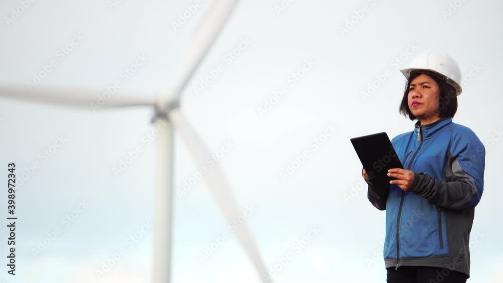 Engineers are working outdoors to check the wind turbine system Engineers are working outdoors to check the wind turbine system