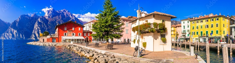 Beautiful lake  Lago di Grada. Panoramic view of Torbole village with colorful houses . Italy