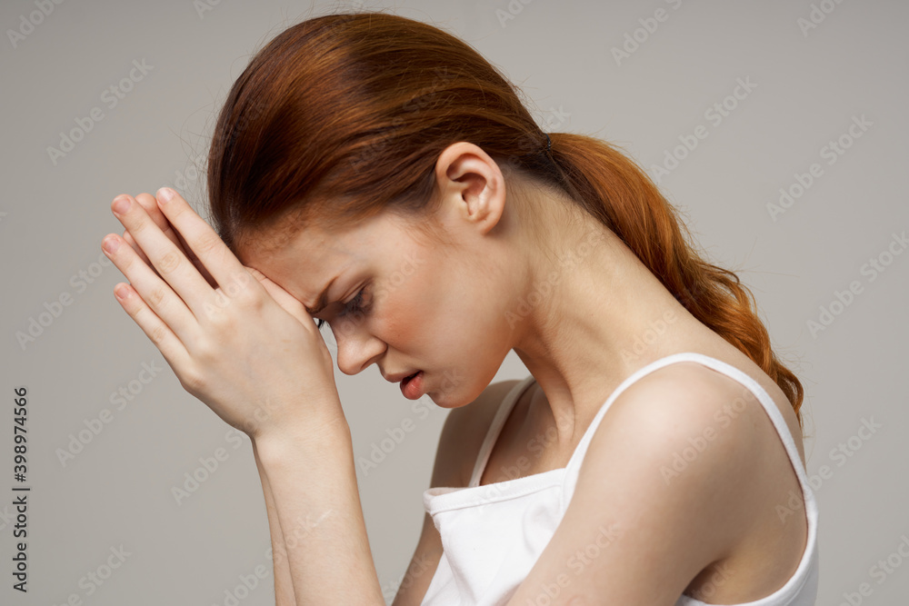 woman holding joined hands near face white t-shirt side view headache woman holding joined hands near face white t-shirt side view headache