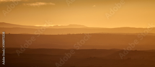 Nice autumn sunset with a cloudy sky over the silhouetted hills