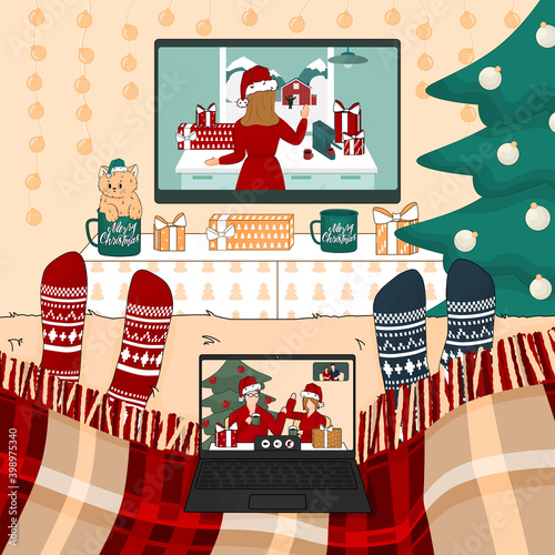 Video call via laptop with friends in bedroom at home. Two people are watching New Year movies on the bed under the Christmas plaid