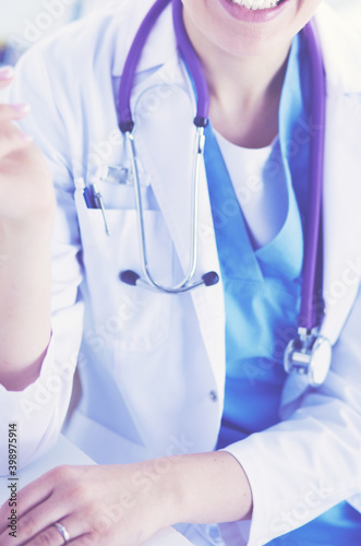 Close up Portrait of friendly female doctor with stethoscope and tablet in hands.