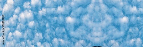  White Altocumulus cloud in blue sky. Australia.