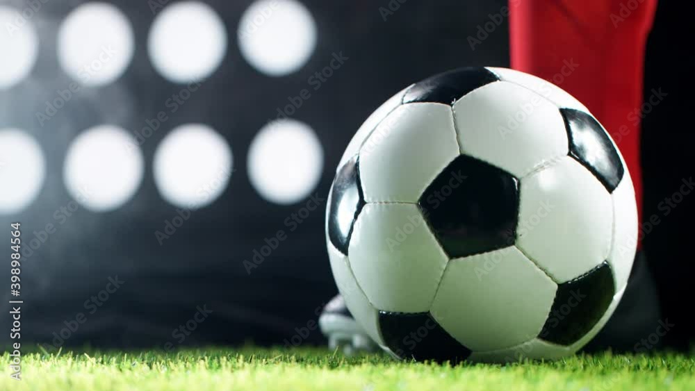 Super slow motion of soccer player kicking the ball. Filmed on high speed cinema camera, 1000fps.