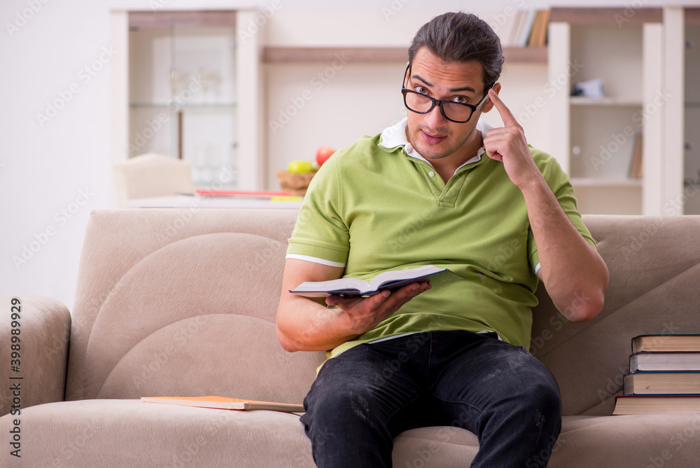 Young male student preparing for exams at home Young male student preparing for exams at home