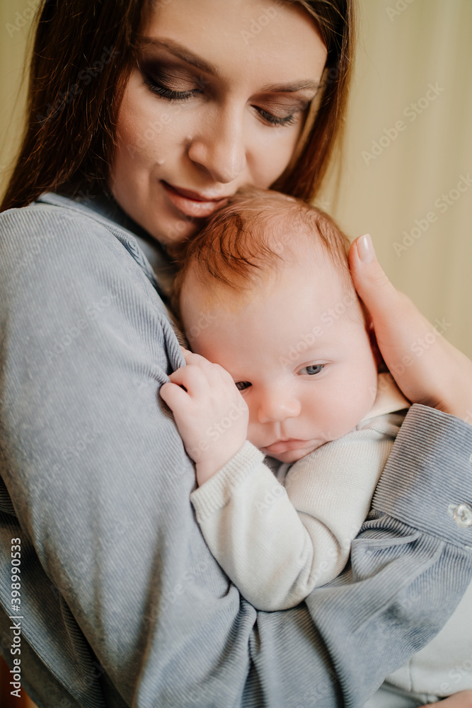 Mom gently holds on her kid in arm. long-awaited baby. Mother's Day. Mom gently holds on her kid in arm. long-awaited baby. Mother's Day.
