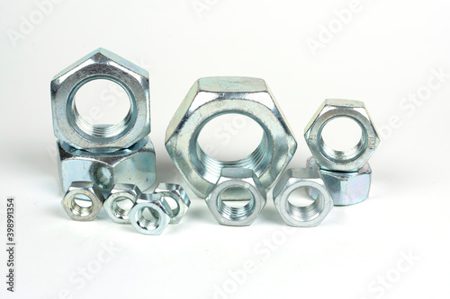 several metal nuts on a white background