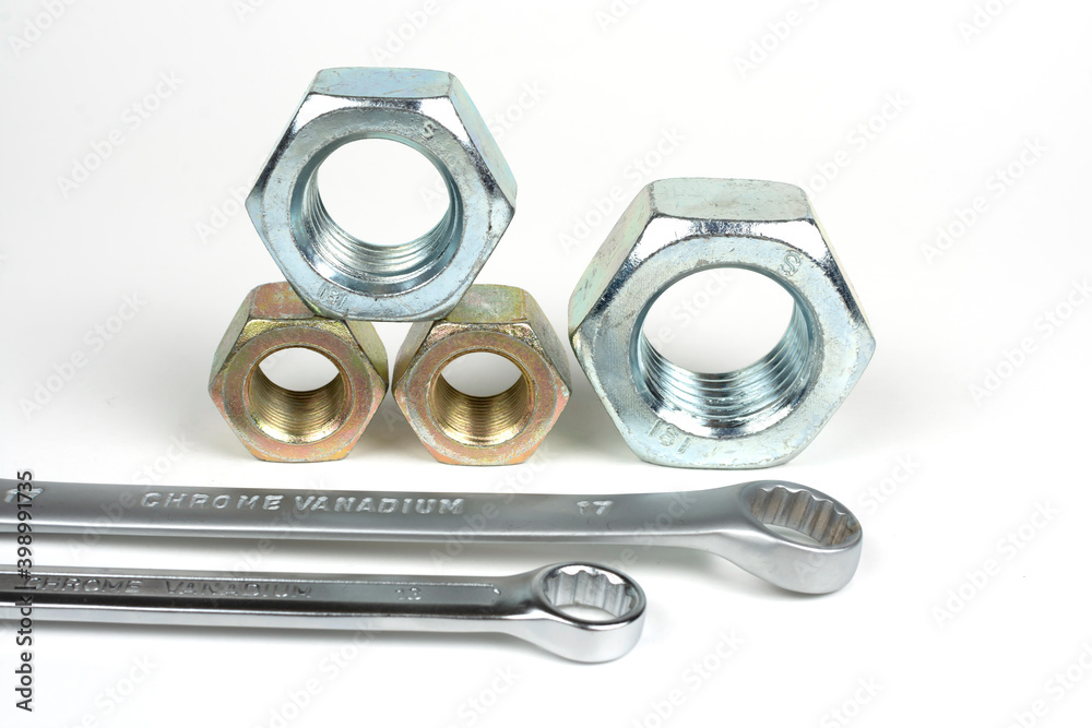 metal nuts with wrenches on a white background metal nuts with wrenches on a white background