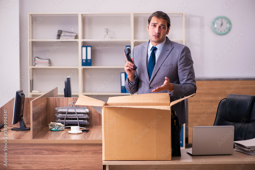Young male employee being dismissed from his work Young male employee being dismissed from his work