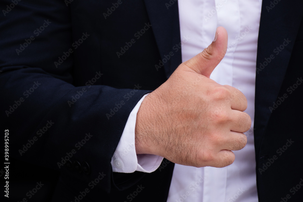 Businessman showing thumbs up, Hand like - close up
