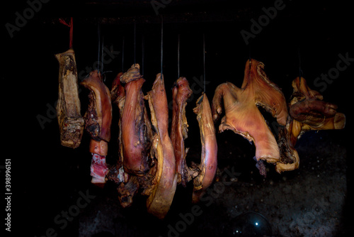  pork meat upstairs kitchen. Dry pork ( called Gac Bep pork) on dark background. This is one of Traditional dishes of ethnic H'Mong people in Ha Giang Province , Viet Nam photo