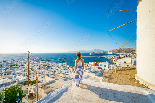 Female tourist looking at Mykonos island in Greece