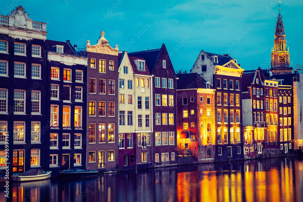 Typical dutch dancing houses at dusk in Amsterdam, Netherlands