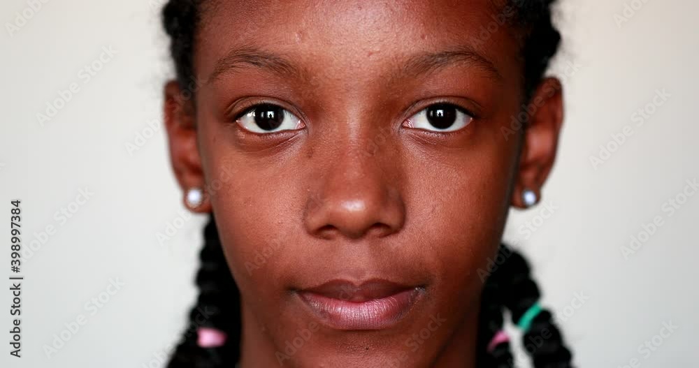 Close-up African black girl face staring camera portrait Close-up African black girl face staring camera portrait